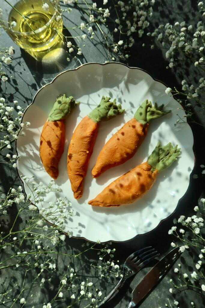 Hand-shaped carrot ravioli with vibrant orange pasta dough and whipped sweet potato lemon filling