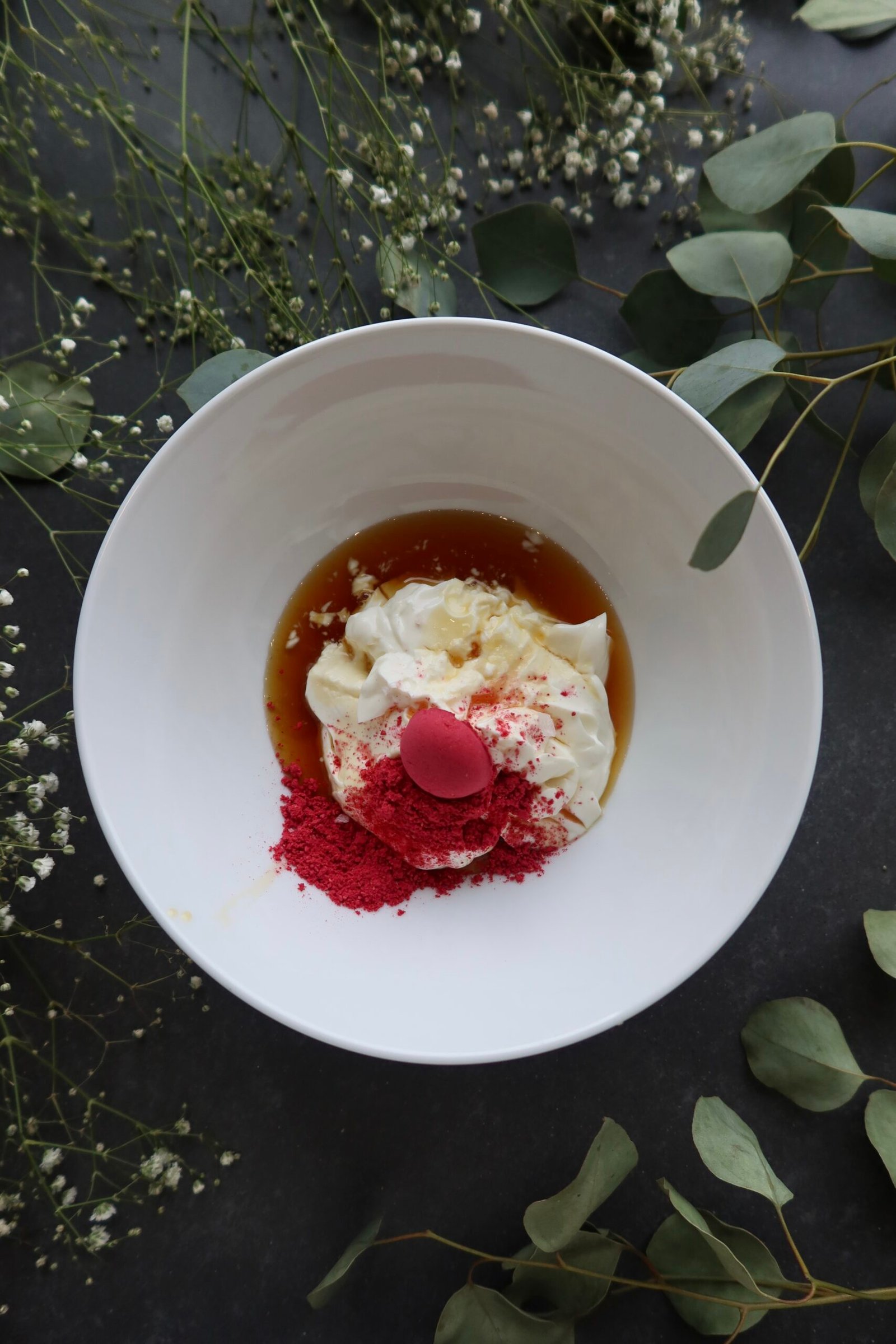 Greek yogurt and raspberry powder in a bowl before being whisked into raspberry whip