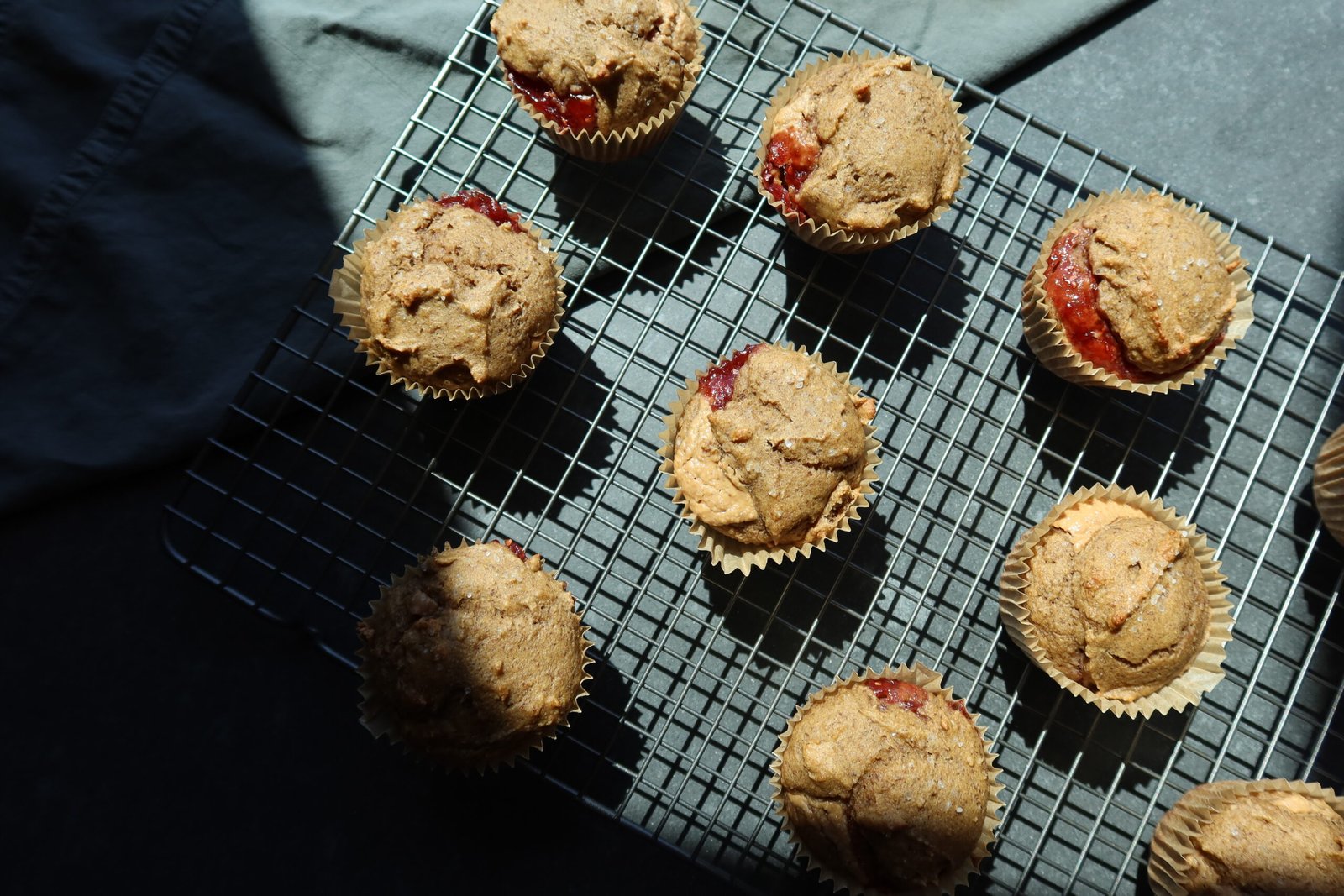 High protein peanut butter and jelly breakfast muffins with gooey PBJ center made with oat flour and date paste