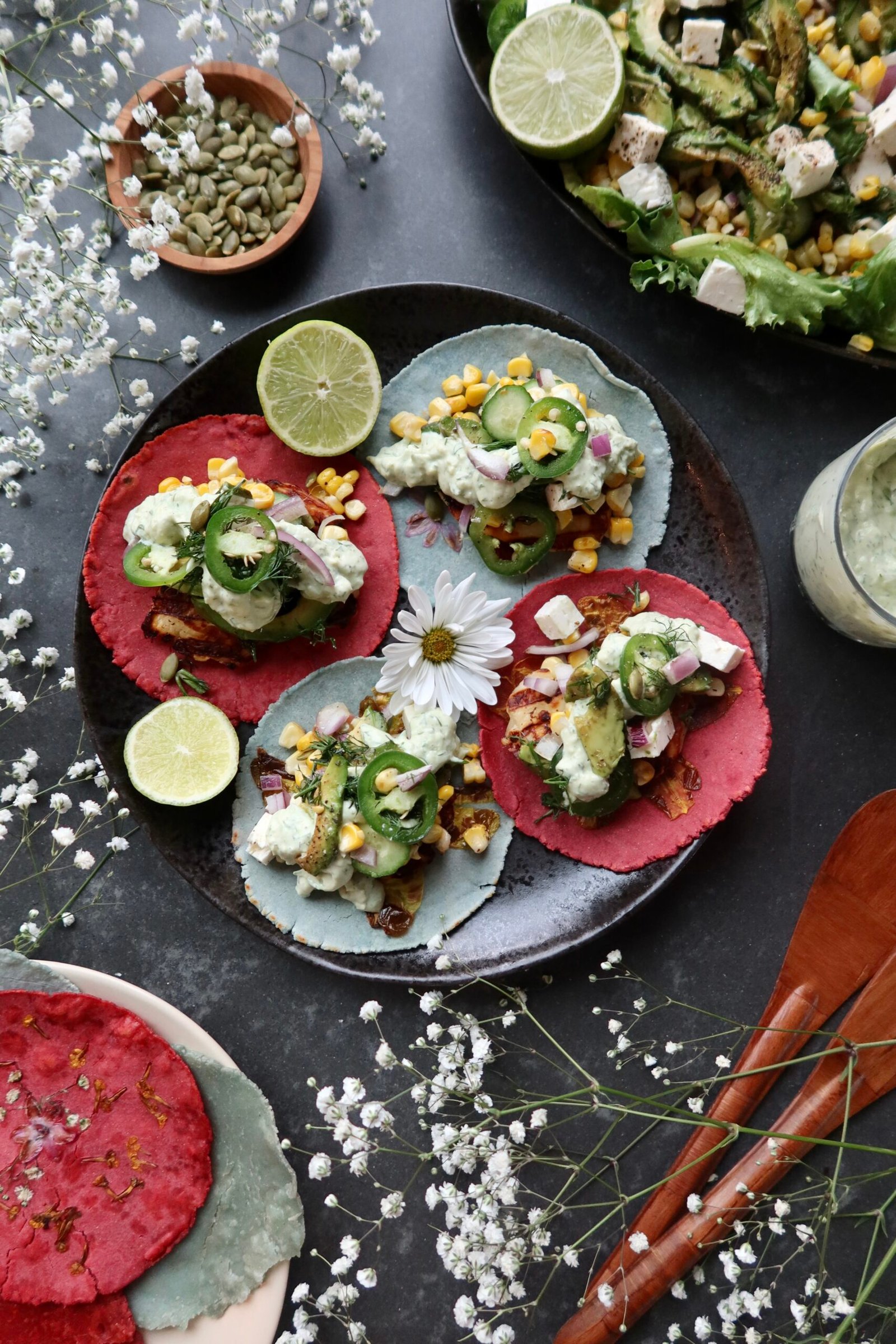 Crispy halloumi tacos with flower pressed tortillas zesty corn salad and cilantro avocado sauce