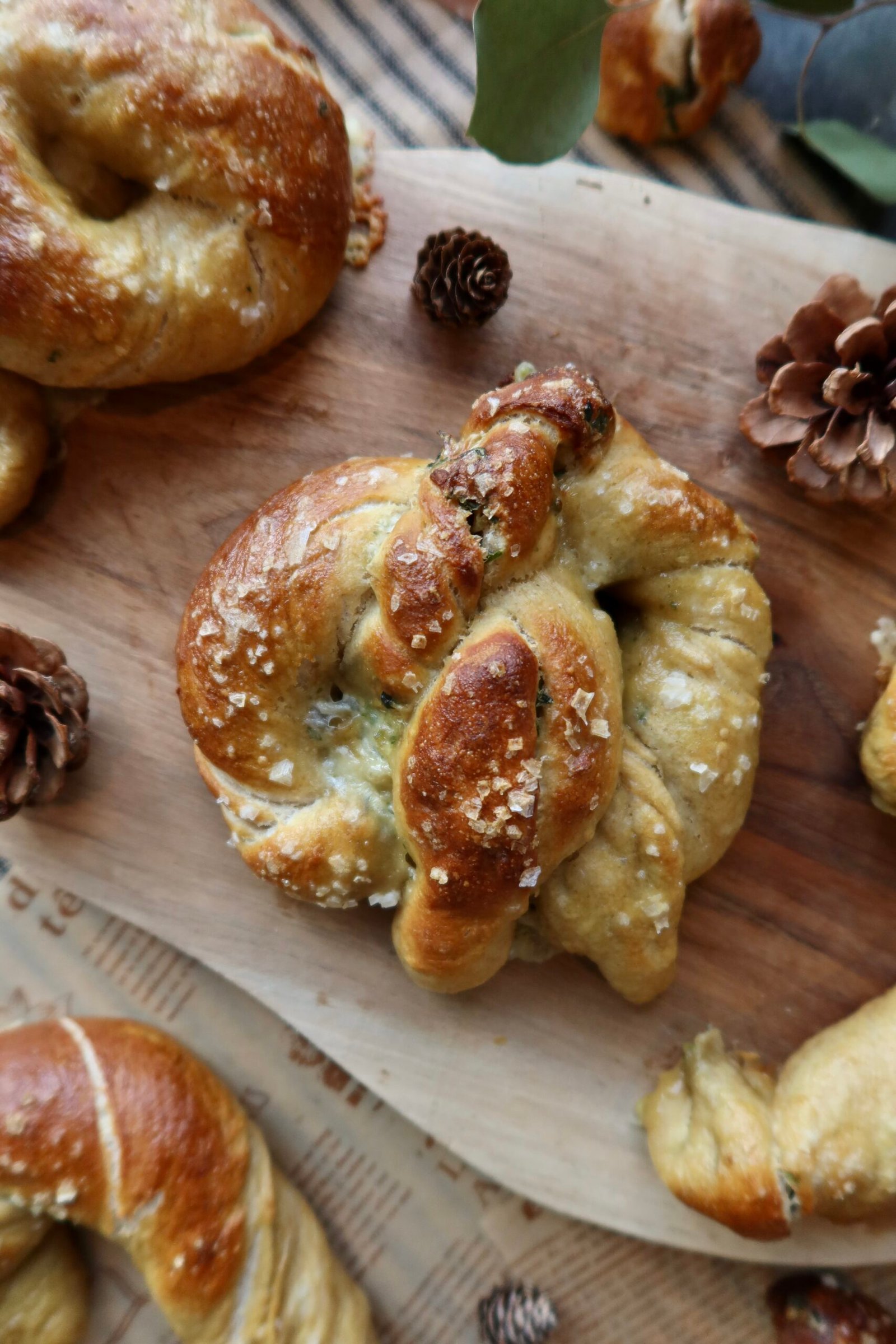 Cheesy spinach artichoke stuffed sourdough pretzels deeply golden with pretzel salt topping