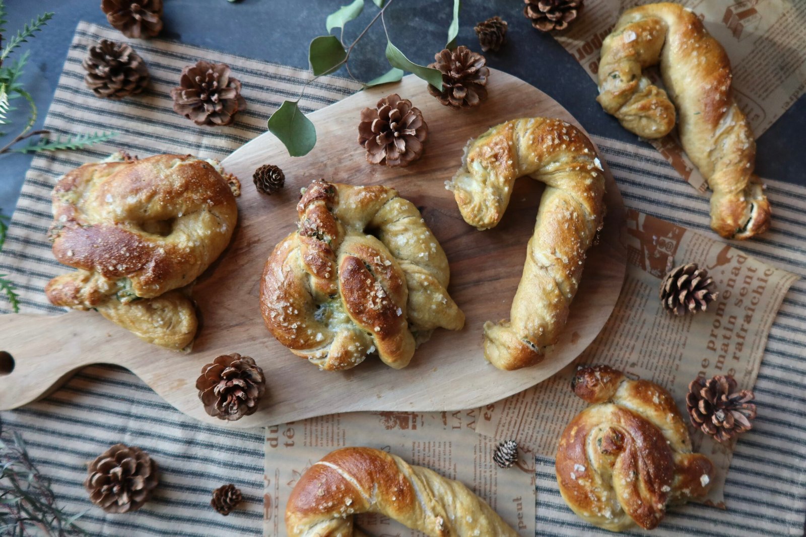 Cheesy spinach artichoke stuffed sourdough pretzels deeply golden with pretzel salt topping