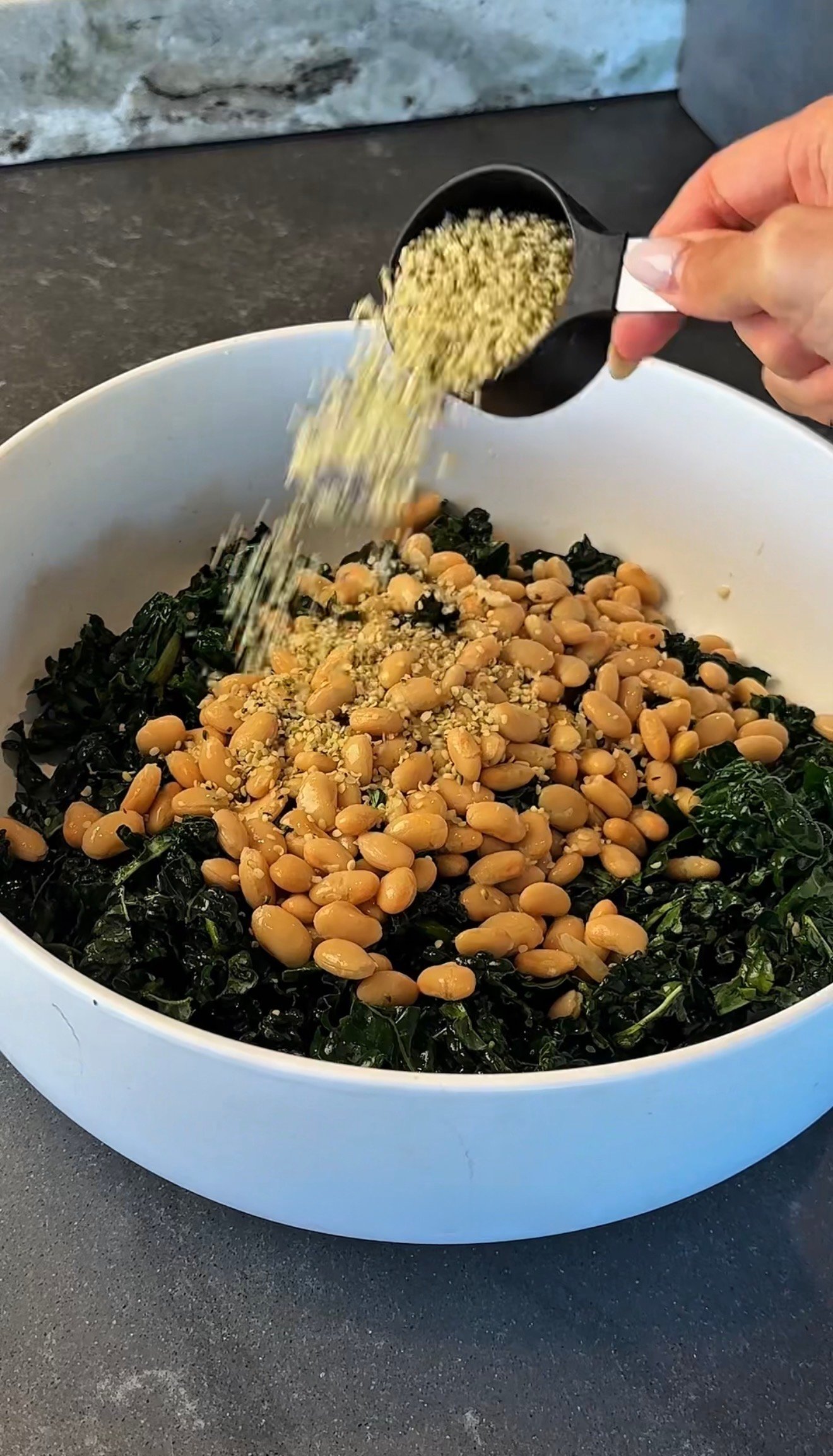 Erewhon white bean kale salad fully assembled with quinoa seeds and beans before dressing