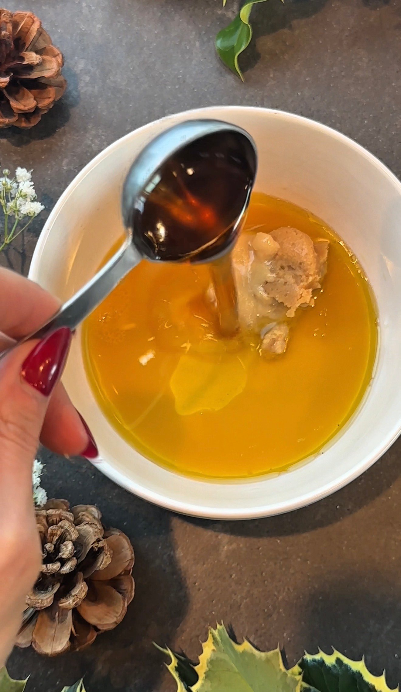 Miso parmesan vinaigrette being poured over winter shaved Brussels sprouts salad