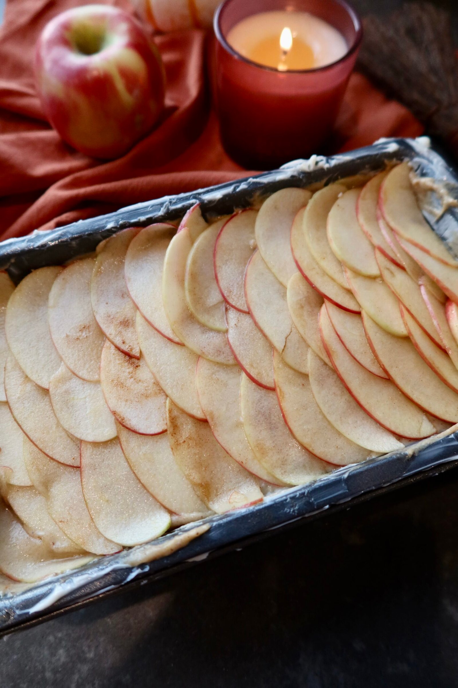 Cinnamon toast crunch brown butter apple cake with thin Honeycrisp apple layers and a caramelized cinnamon maple sugar crust.