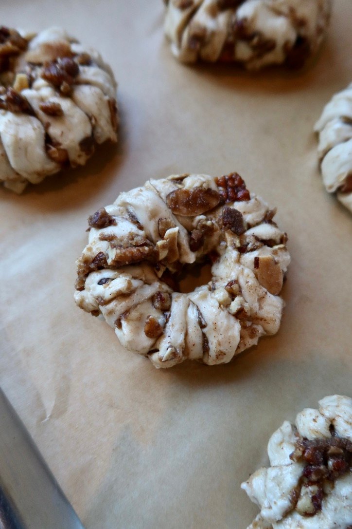 Easy puff pastry apple donuts with cinnamon apples, brown butter pecans and maple vanilla glaze