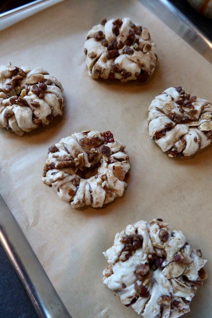 Easy puff pastry apple donuts with cinnamon apples, brown butter pecans and maple vanilla glaze
