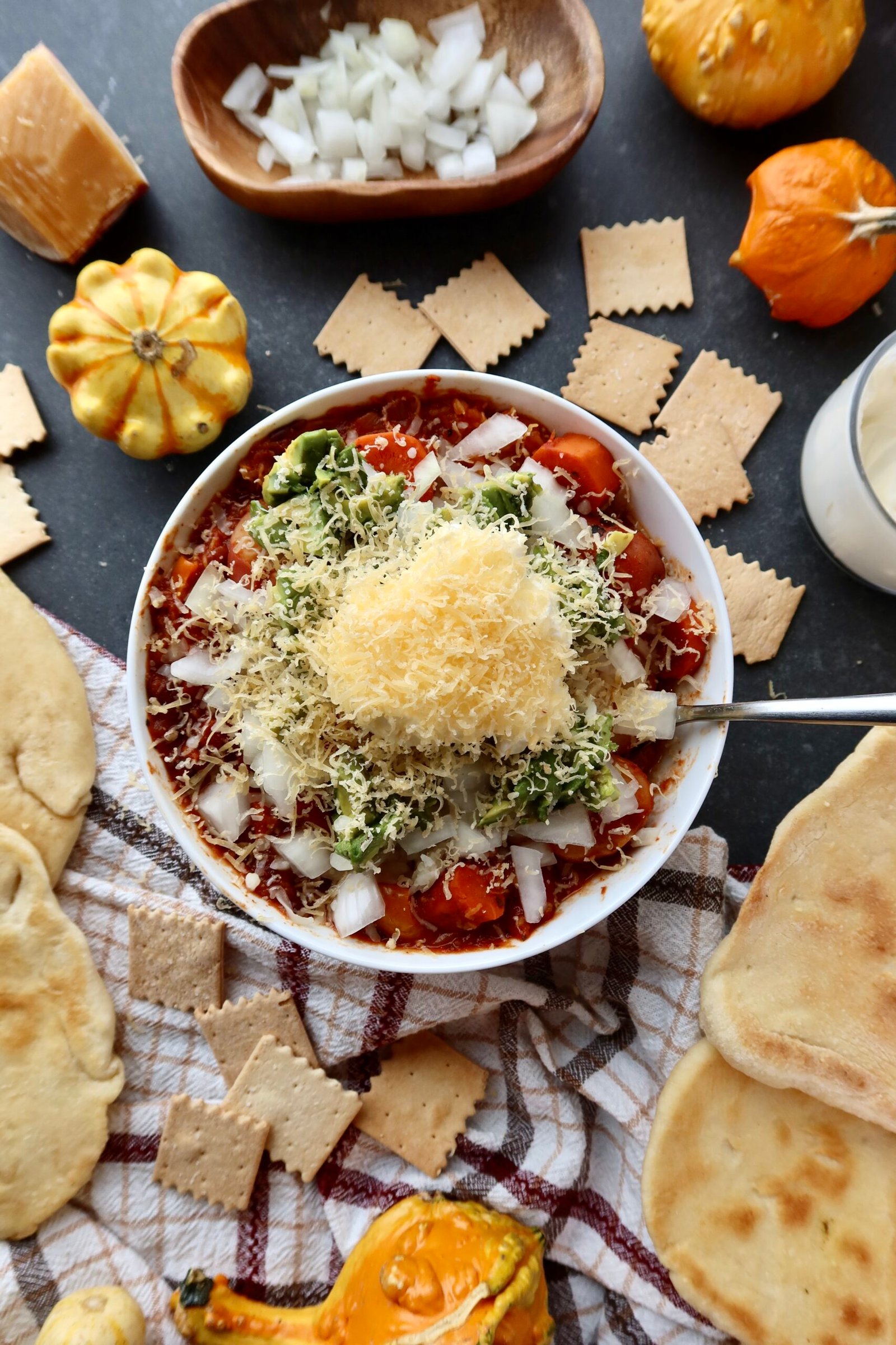 Vegetarian pumpkin chili with potatoes, carrots and beans served with homemade buttered naan