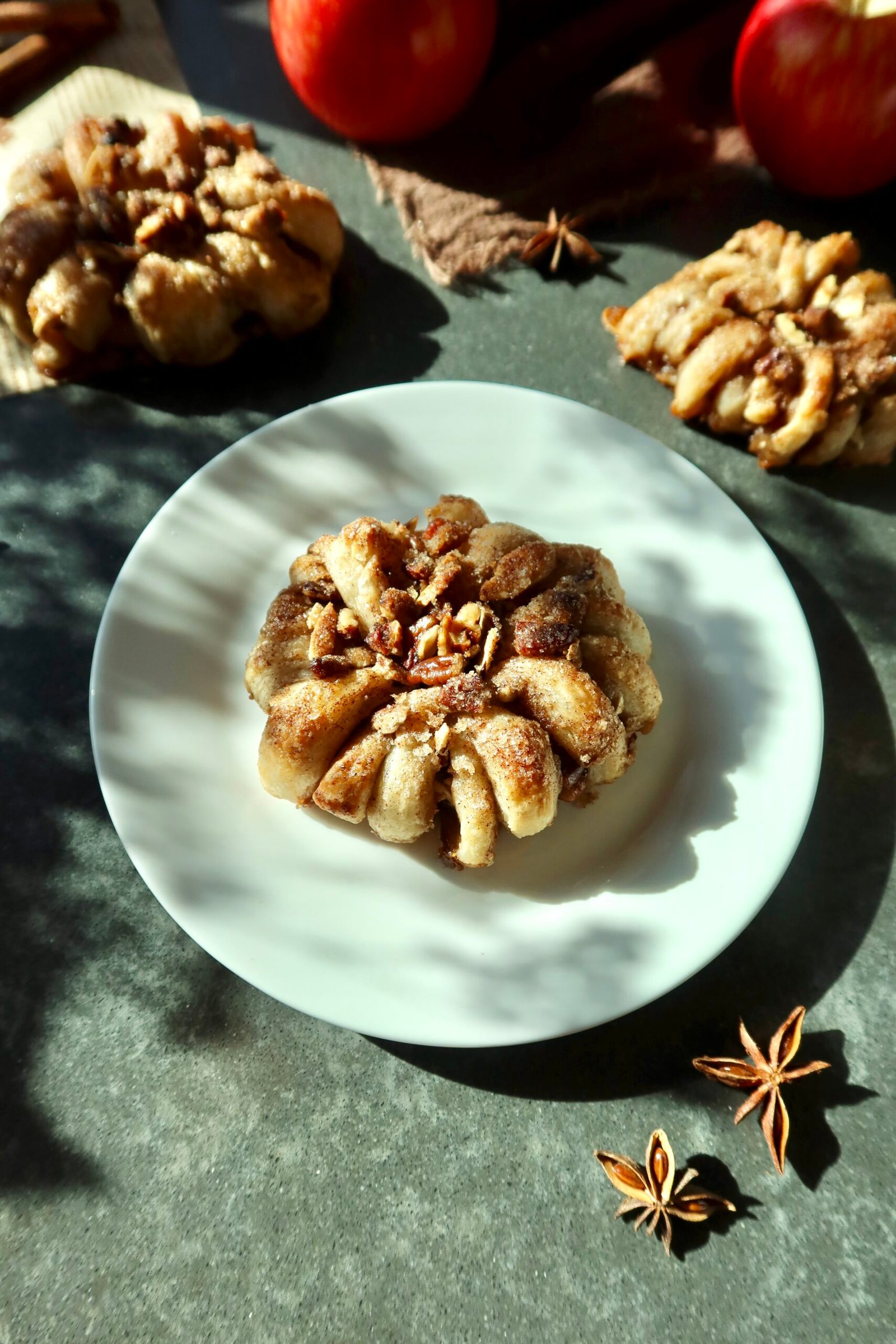 Easy puff pastry apple donuts with cinnamon apples, brown butter pecans and maple vanilla glaze
