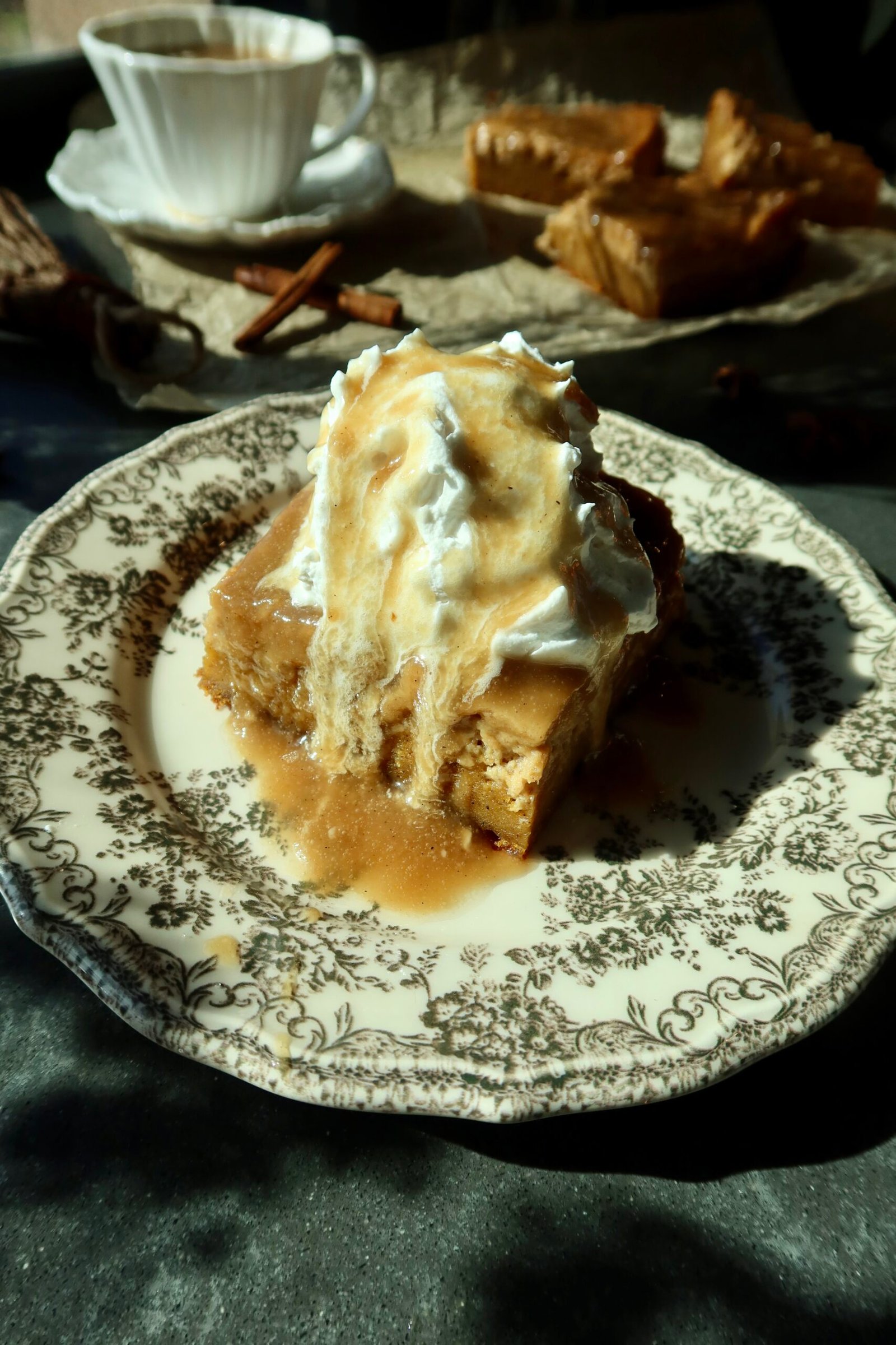 Deep-dish brown butter maple pumpkin gooey cake with vanilla ice cream and salted maple tahini caramel